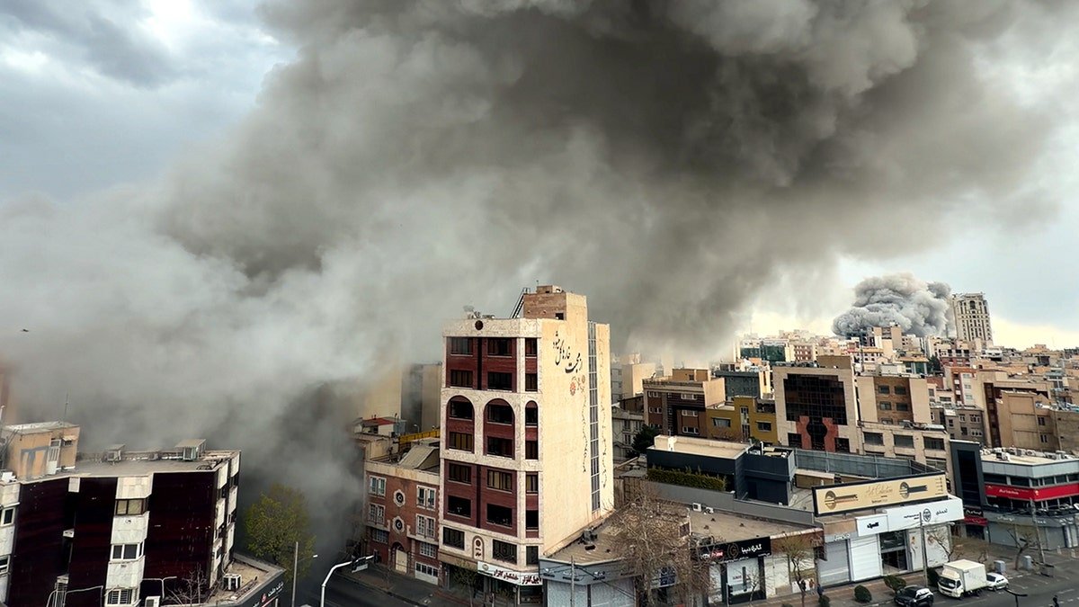 Plumes of smoke rising over city