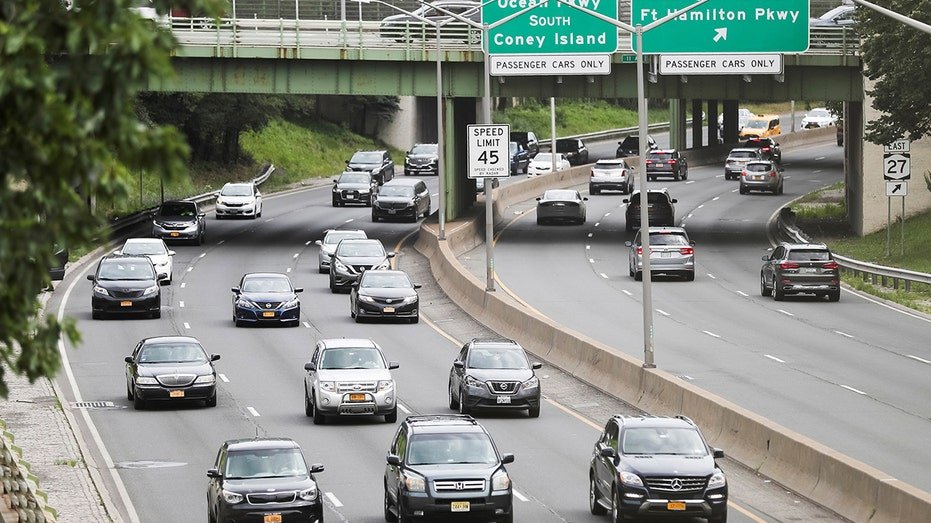 Vehicles drive on a highway in New York.