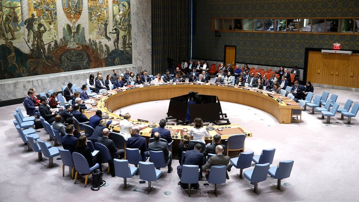 Diplomats gather around the chamber table during a United Nations Security Council meeting in New York.