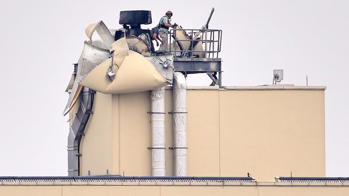 Person inspects damage at U.S. embassy in Baghdad