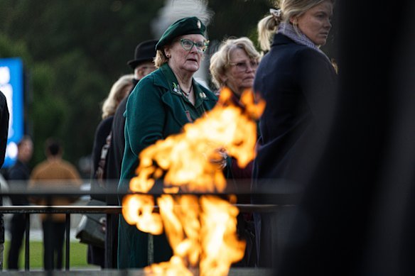 People gather at the eternal flame.
