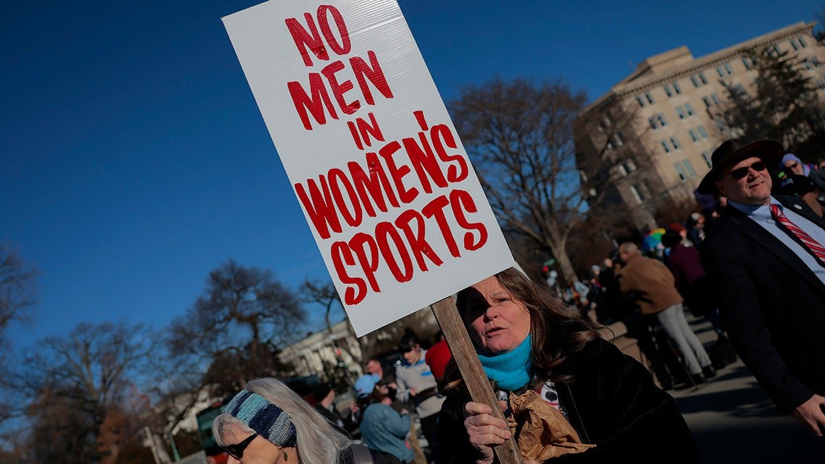 Protester Heather Diehl holding No men in women's sports sign outside Supreme Court in Washington D.C.