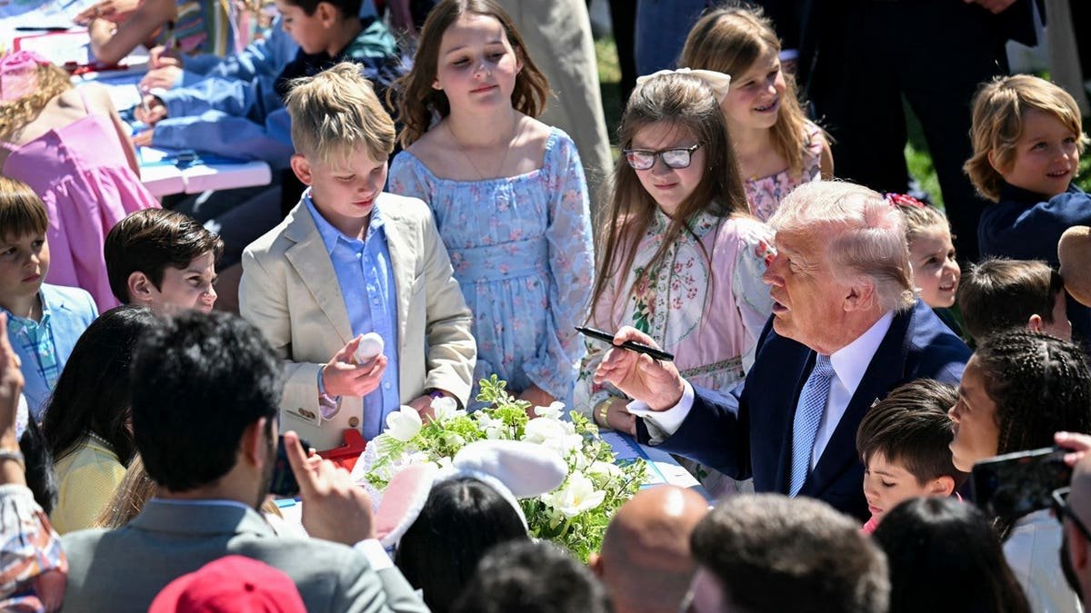 Trump coloring with kids at table egg roll 2026