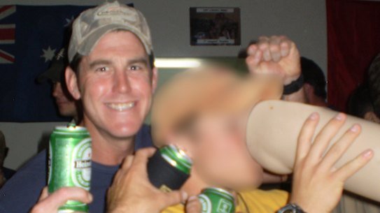 Ben Roberts-Smith (left) with a former colleague drinking from the prosthetic leg of a dead Afghan man in 2012.