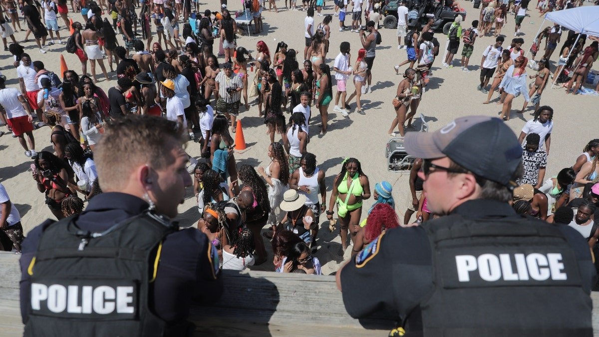 Police overlook a crowd at Orange Crush on Tybee Island on Saturday, April 19.