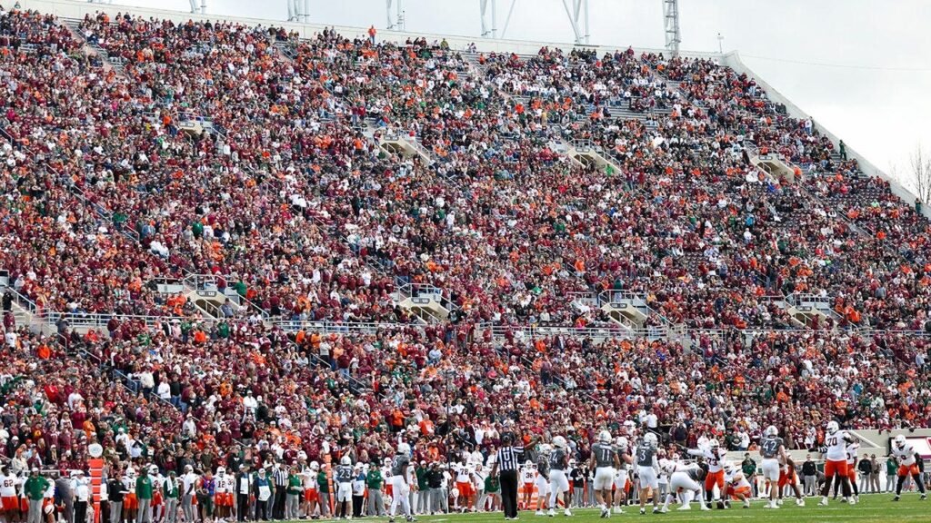 Skydiver’s parachute gets stuck on scoreboard at Virginia Tech spring game in harrowing scene