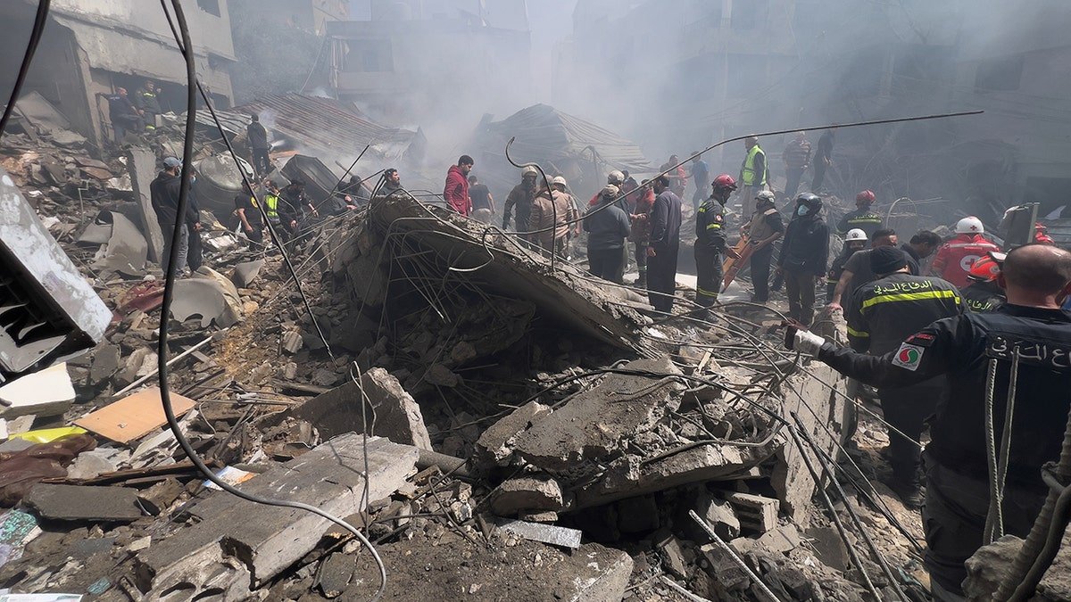 Rescue workers searching for victims at the site of an Israeli airstrike in Beirut