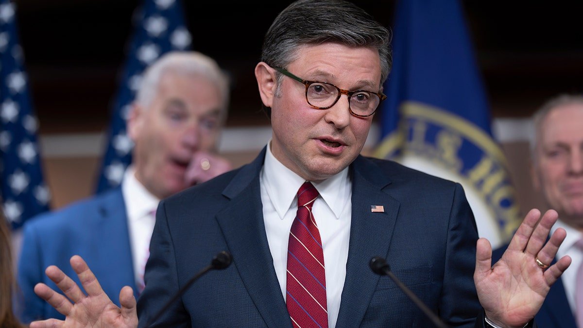 Speaker of the House Mike Johnson gesturing while speaking to reporters at the U.S. Capitol