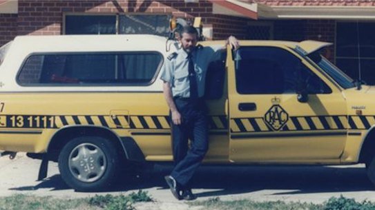 Malcolm Harris with his patrol car.