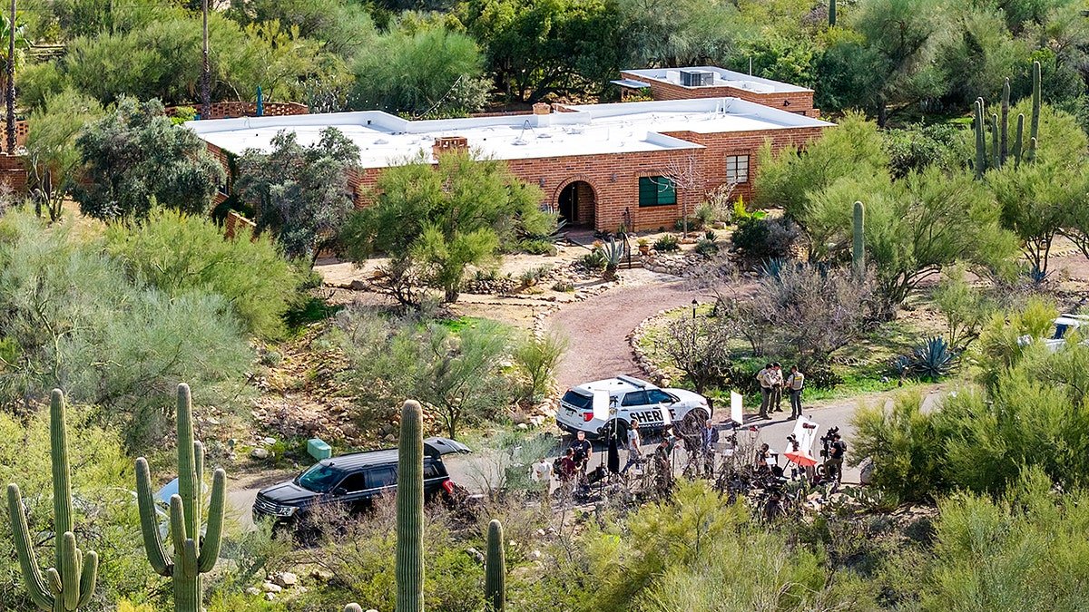 Law enforcement and news broadcasters outside Nancy Guthrie's residence in Tucson