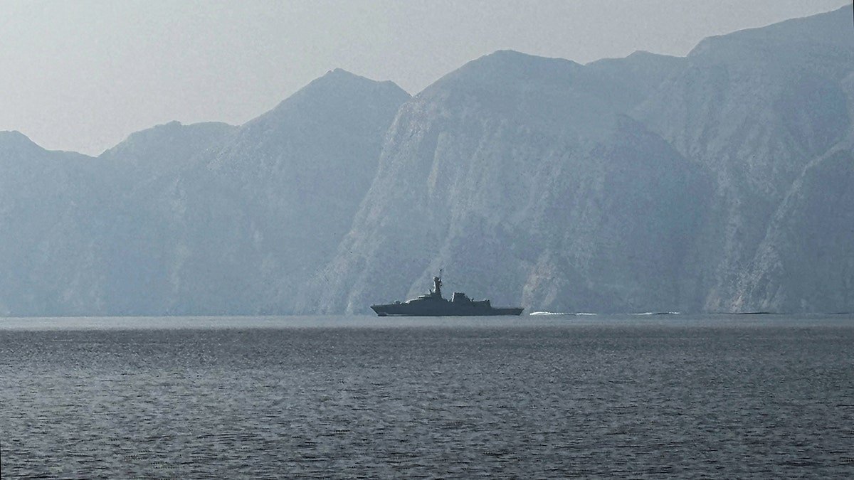 A navy vessel sailing in the Strait of Hormuz waterway.