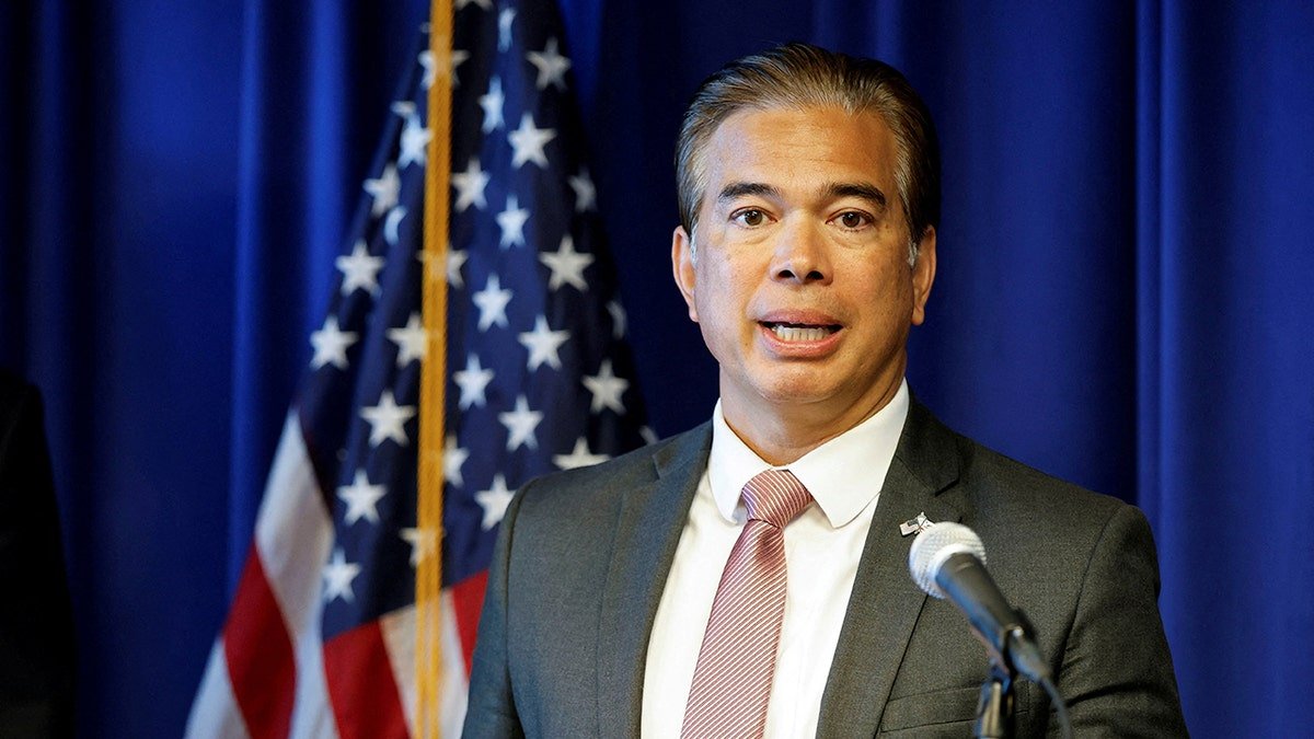 California Attorney General Rob Bonta speaking at a news conference in front of an American flag