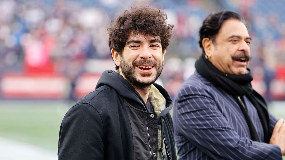 Jacksonville Jaguars owners Tony and Shad Khan standing on the sidelines at Gillette Stadium