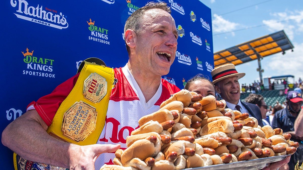 Joey Chestnut posing with hot dogs at Maimonides Park in Brooklyn