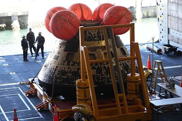 Bearing the scars of its fiery reentry, the Artemis II capsule sits safely aboard the USS John P. Murtha on Saturday.