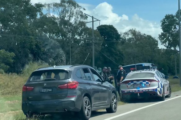Police with two of the cars that were stopped near Alligator Creek.
