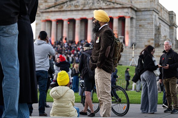 People stop to pay their respects on Anzac Day.