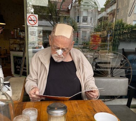 On the road to recovery: Ross Gittins enjoying a trip to the cafe after being released from hospital. 