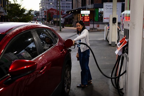Elizabeth Arevalo fills up petrol at an Ampol on Liverpool Road in Croydon. 