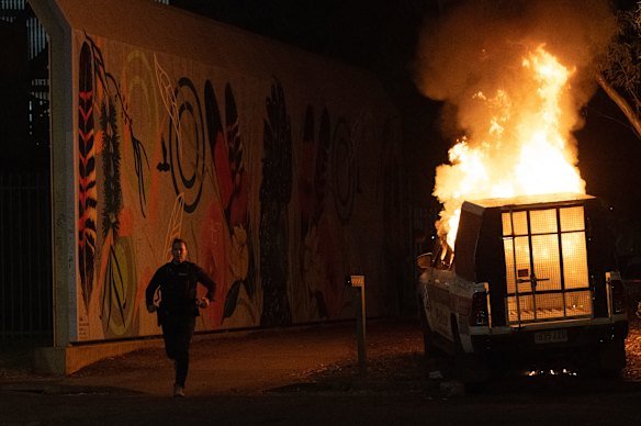 A police van is set on fire.