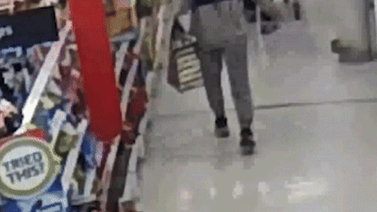 A woman ditches a bag filled with products before being confronted by security at Coles Prahran.