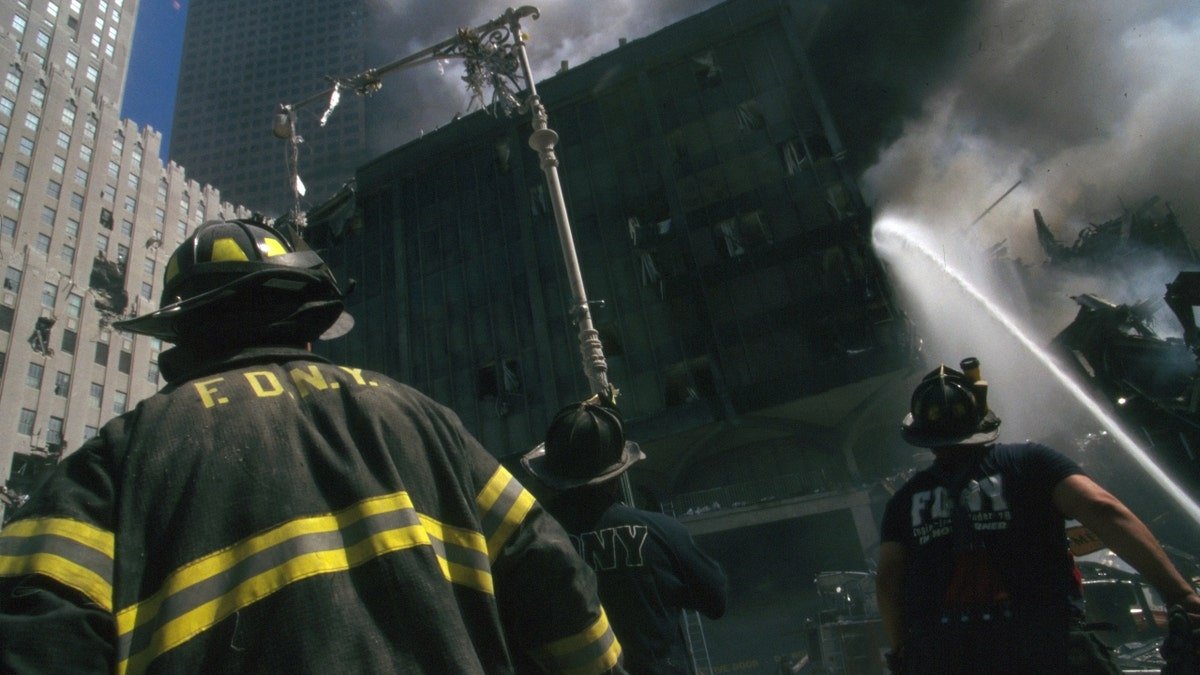 New York firefighter standing amid rubble at World Trade Center site