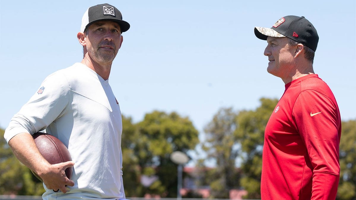 Head Coach Kyle Shanahan and General Manager John Lynch talking at 49ers rookie training camp