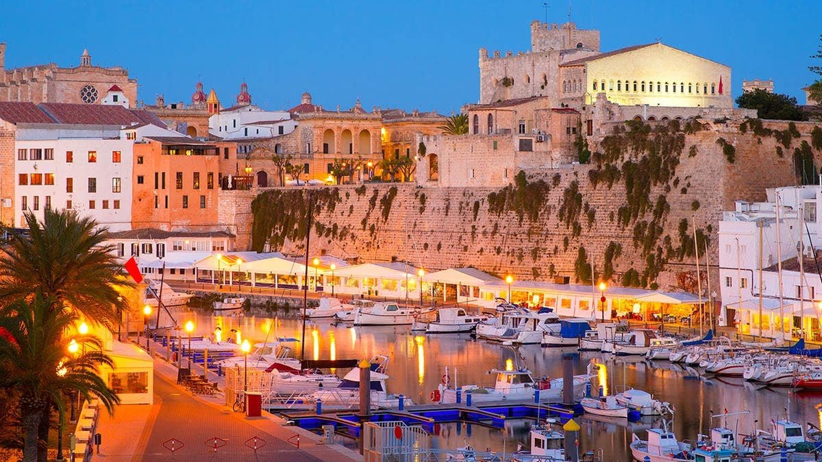 Menorca marina at sunset with town hall and cathedral visible