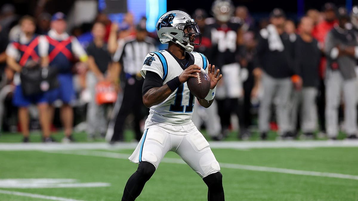 PJ Walker looks to pass during an NFL game