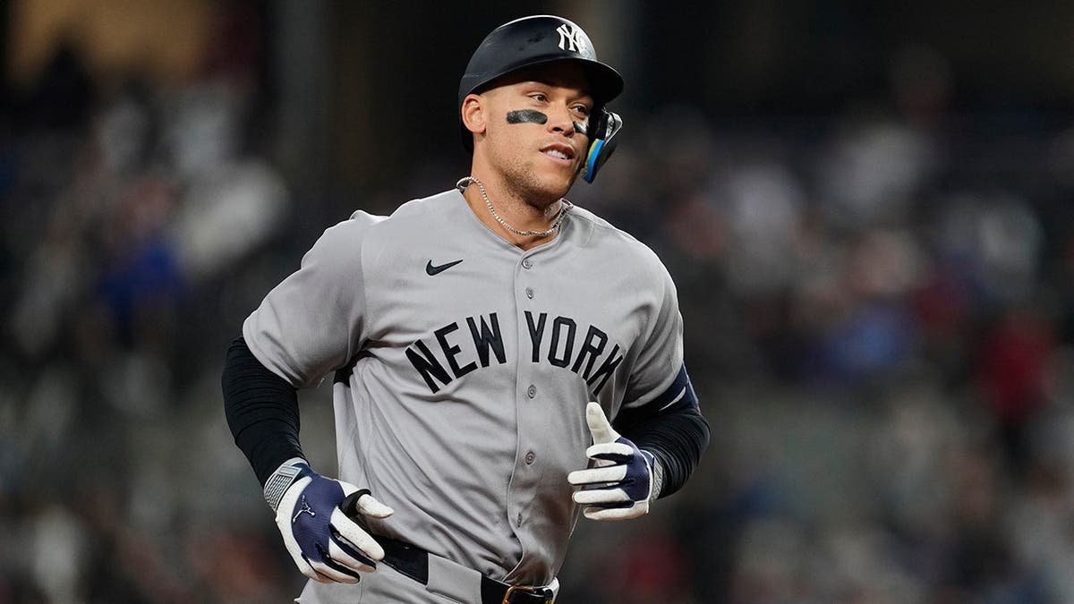 New York Yankees' Aaron Judge rounding bases after hitting a home run.