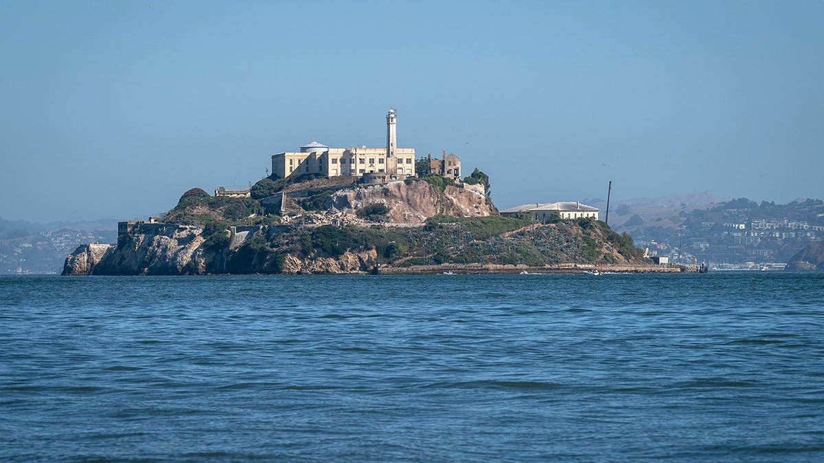 A general view of Alcatraz Island in San Francisco Bay with water surrounding it.