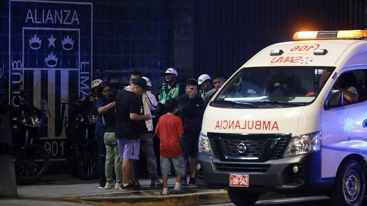 Relatives waiting at entrance of Alejandro Villanueva Stadium after accident