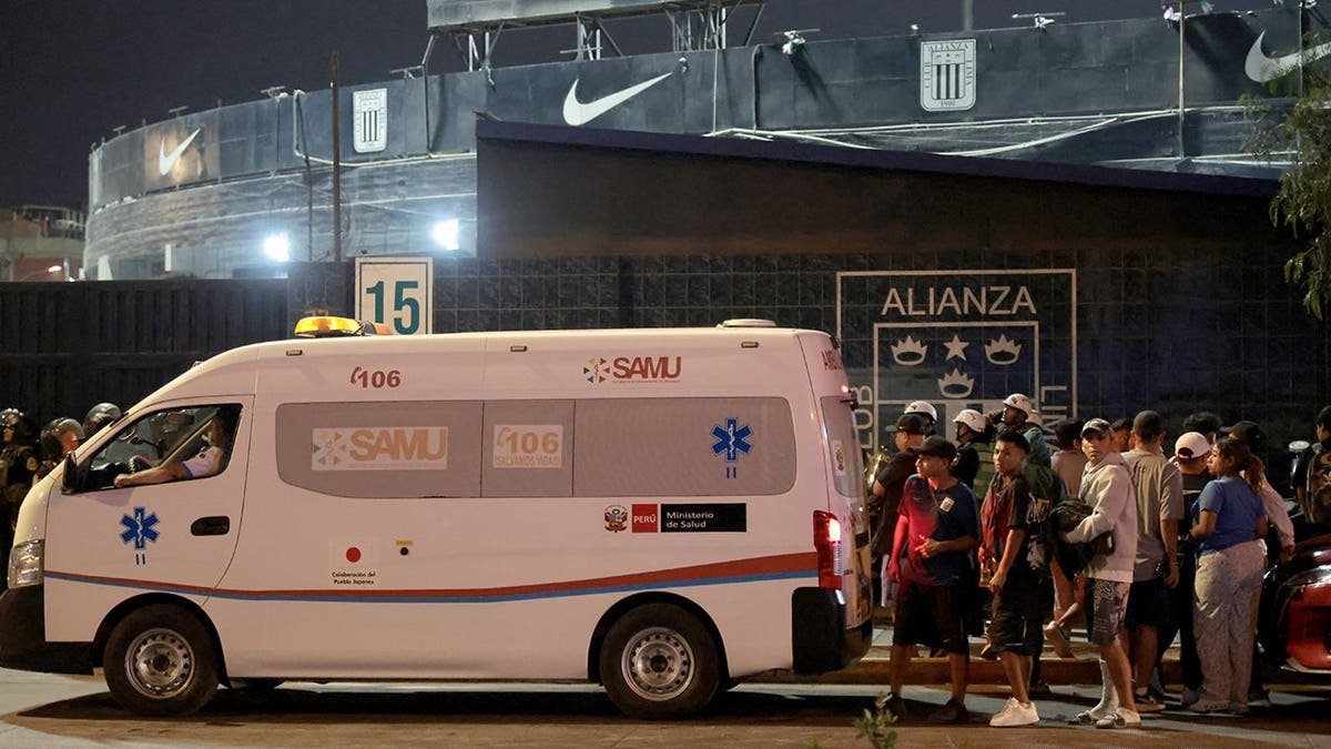 Relatives waiting at entrance of Alejandro Villanueva Stadium in Lima