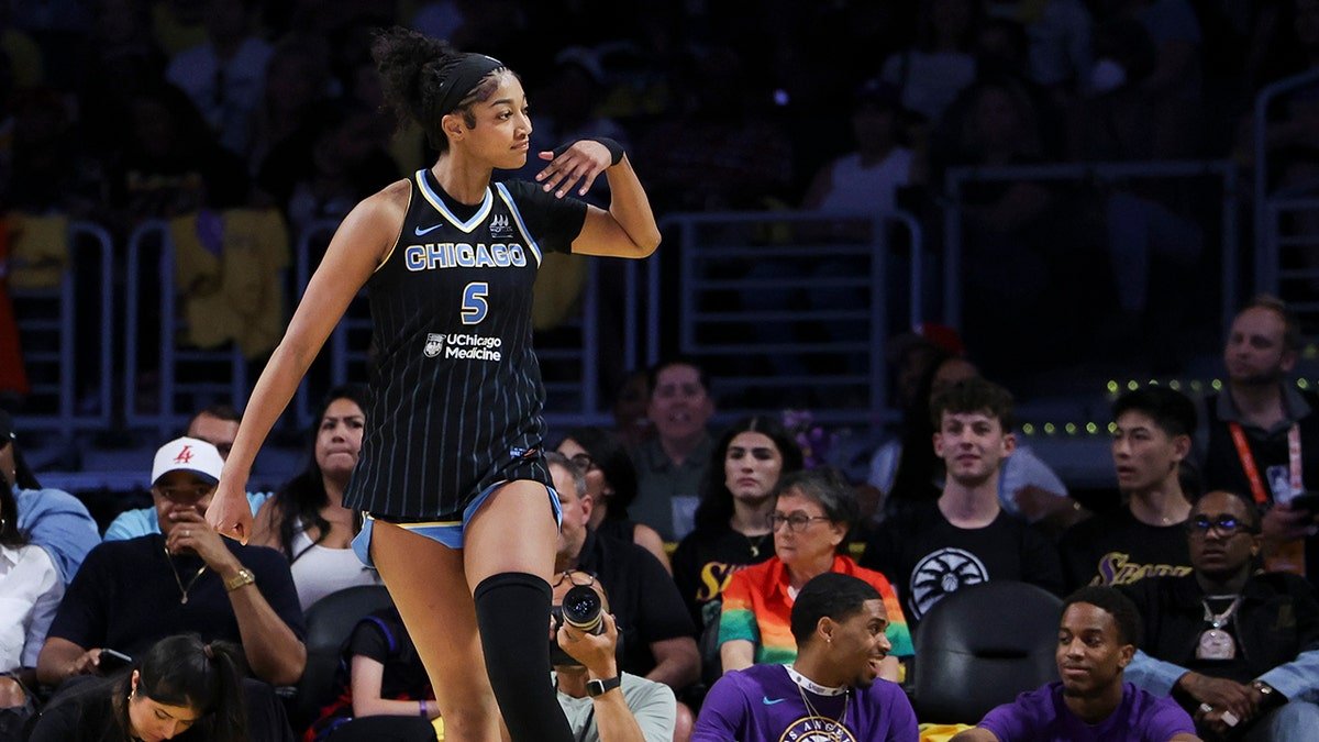 Chicago Sky forward Angel Reese gestures towards the crowd during a basketball game.