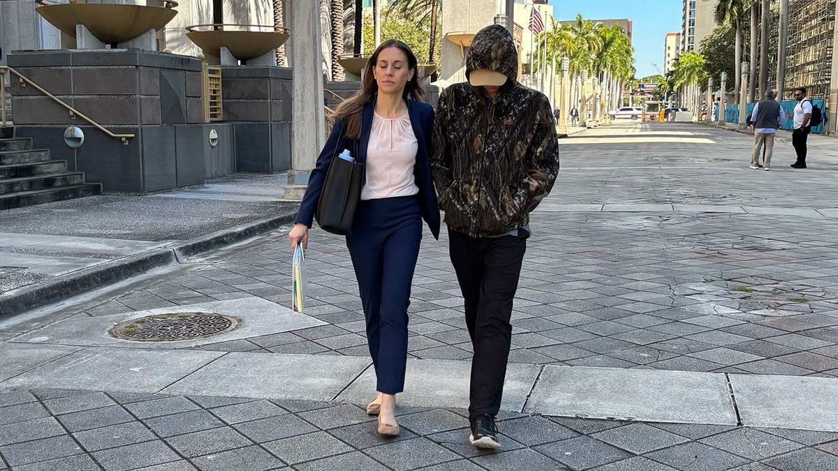 Anna Kepner’s stepbrother and his attorney walking outside of a Federal Court building in Miami.