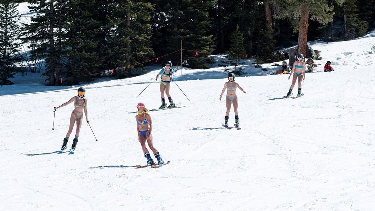 A group of friends skiing in swimsuits at Arapahoe Basin Ski Resort in Colorado