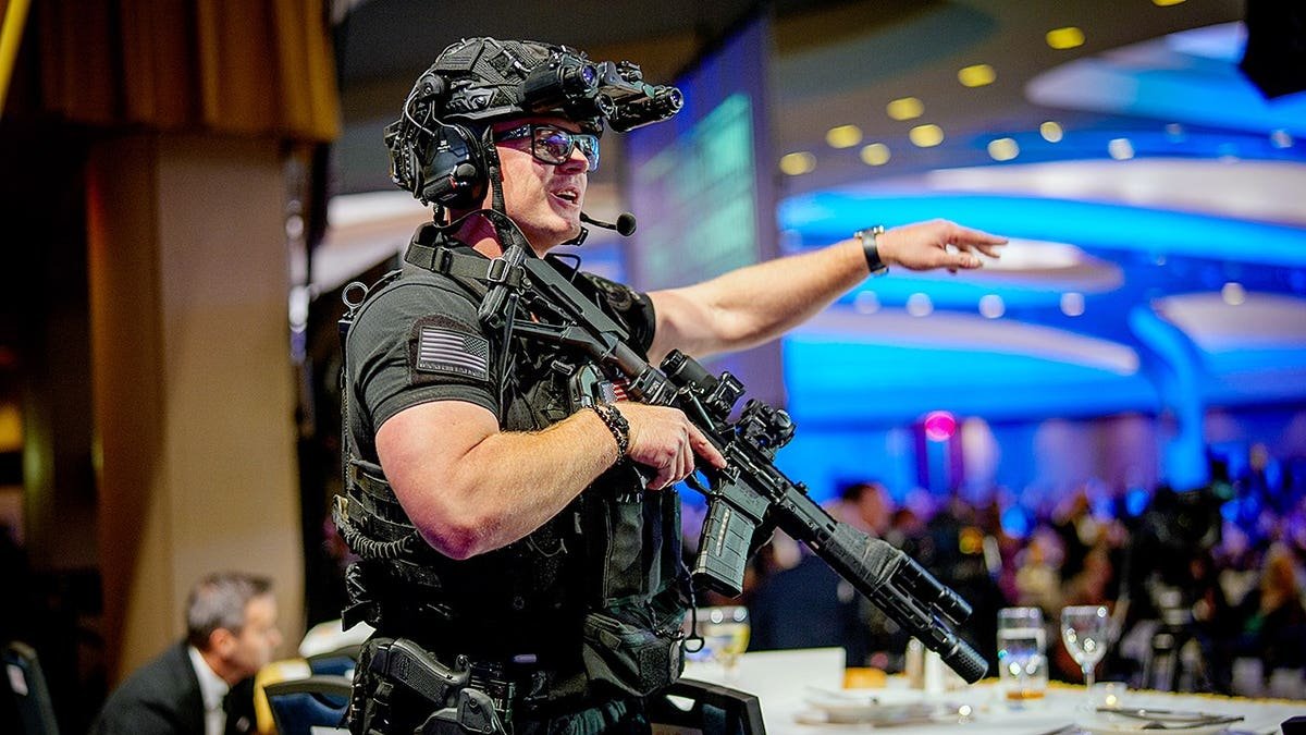 Armed Secret Service agents standing on stage at the Washington Hilton.
