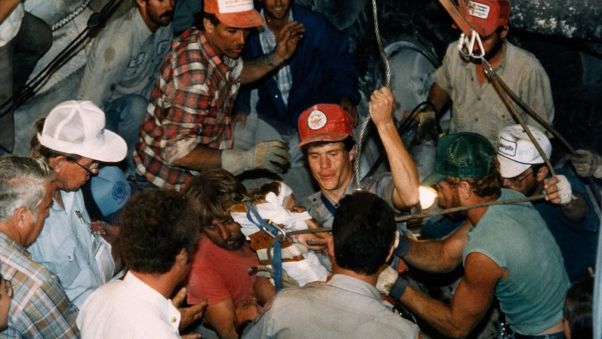 Rescuers working to free Baby Jessica from a narrow hole