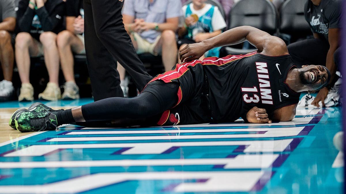 Bam Adebayo reacting after a fall during a basketball game at Spectrum Center.
