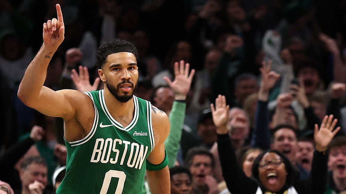 Jayson Tatum celebrating after scoring during a basketball game at TD Garden.