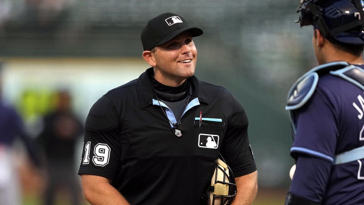 Home plate umpire Brock Ballou talking with Tampa Bay Rays catcher Alex Jackson at Oakland-Alameda County Coliseum