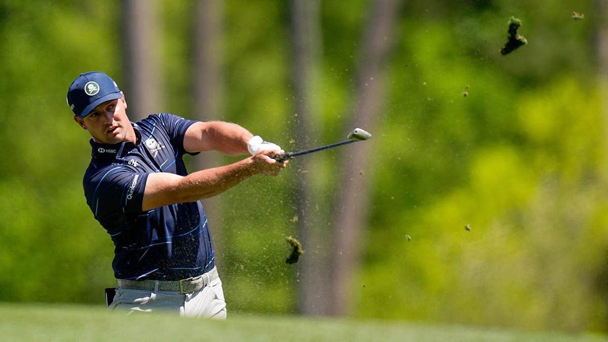Bryson DeChambeau hitting a tee shot on the 12th hole at Augusta National Golf Club