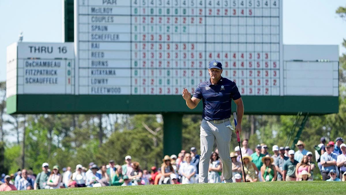 Bryson DeChambeau acknowledges patrons on the 17th green at Augusta National Golf Club