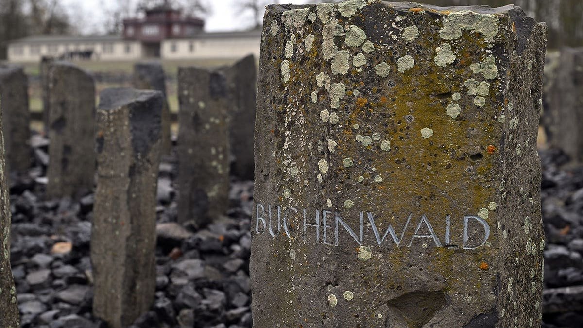 Memorial stone with inscription Buchenwald near former concentration camp gate in Weimar