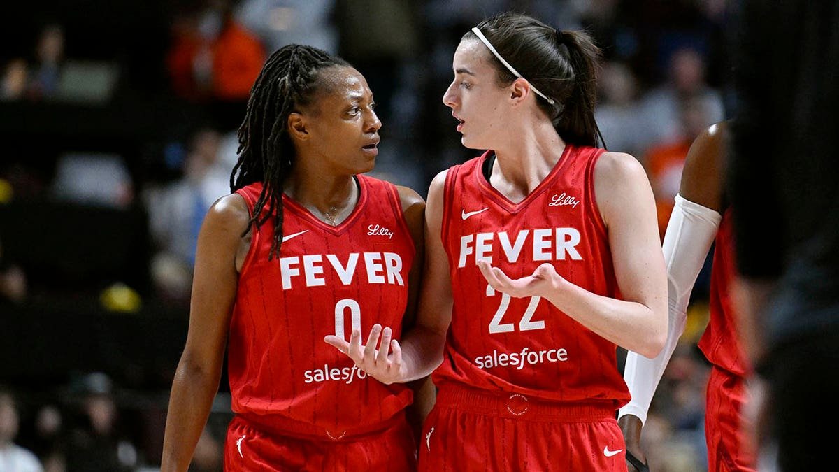 Indiana Fever guards Kelsey Mitchell and Caitlin Clark talking on basketball court
