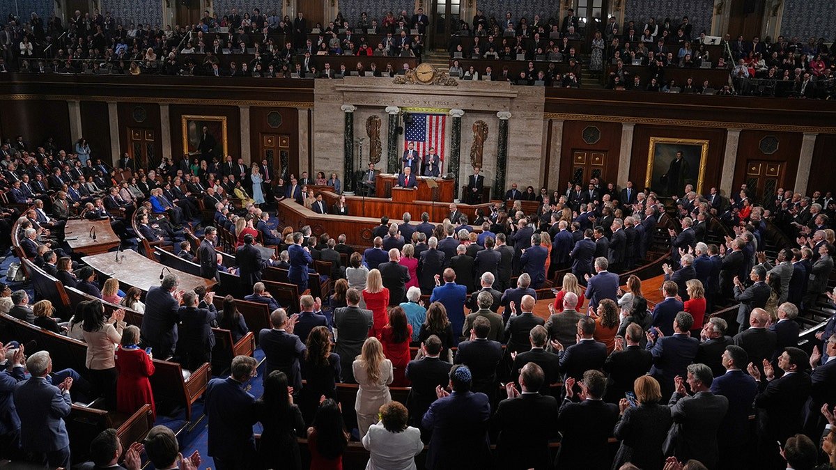 President Donald Trump speaking at a podium in the House chamber at the U.S. Capitol