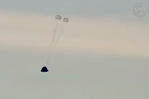 The Orion spacecraft’s crew capsule, named Integrity, deploys its first parachutes.