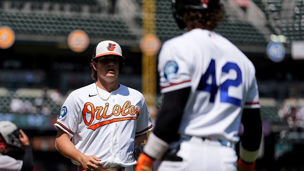 Baltimore Orioles' Coby Mayo celebrating with Blaze Alexander after scoring a run.
