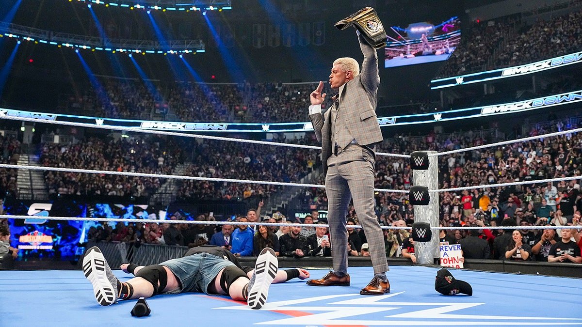 Cody Rhodes stands over John Cena