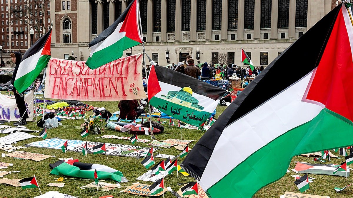 Anti-Israel students sitting and standing on Columbia University central lawn